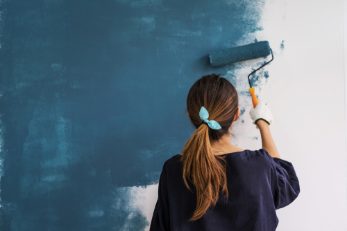 Young,Asian,Happy,Woman,Painting,Interior,Wall,With,Paint,Roller